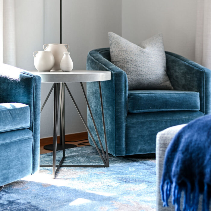 Swivel chairs in living area with concrete side table